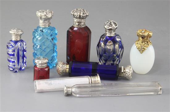 A collection of nine assorted early 20th century silver mounted scent bottles, largest 15cm.